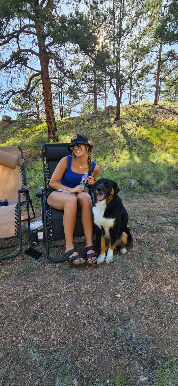 Sidney relaxing at camp with dog